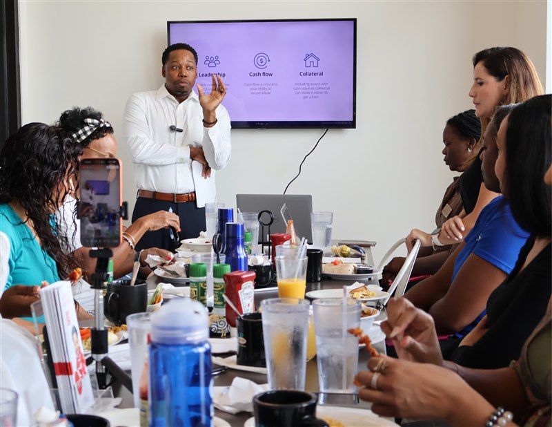 Speaker leading a conversation around the breakfast table