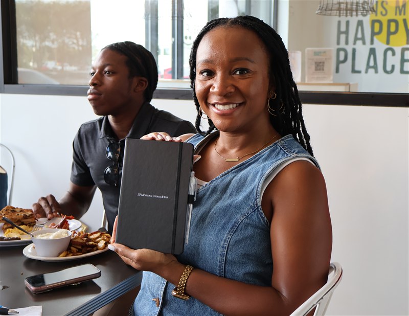 Guest holding a notebook at breakfast