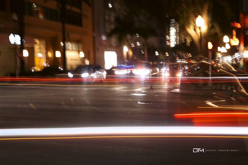 Night street scene with sweeping traffic light trails